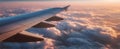 The airplane wing gliding through the clouds at sunset over a serene sky AI generated image Royalty Free Stock Photo