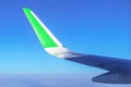 Airplane wing with green stripe. Travel with eco friendly airline. Reducing carbon emissions concept.