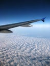 Airplane wing over blue sky with clouds view Royalty Free Stock Photo