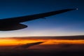 Airplane wing over clouds at sunset Royalty Free Stock Photo