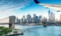 Airplane wing over New York City skyline