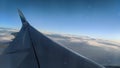 Airplane wing seen from inside the plane during flight Royalty Free Stock Photo