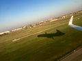 Airplane wing and shadow at take off