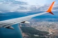 Airplane wing in the sky against the background of the sea coast in Antalya Turkey. Aerial view of the Turkish Riviera. Royalty Free Stock Photo