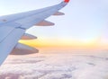 Airplane wing in the sky at beautiful sunset, airplane flight in the sky with copy space