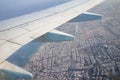 Airplane wing on the sky and over land with building of Tel Aviv city and the Mediterranean sea Royalty Free Stock Photo