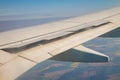 Airplane wing with the spoiler open on the sky over land Royalty Free Stock Photo