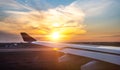 Airplane wing at sunset. travel, air travel. Flight during dawn, a beautiful view in window of an airplane with bright sky Royalty Free Stock Photo