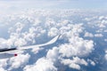 Airplane wing view out of the window the beautiful white cloud with blue sky background, Travel and Holiday vacation concept Royalty Free Stock Photo