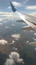 Airplane wing view out of the window on the cloudy sky background. Holiday vacation background. Wing of airplane flying above the Royalty Free Stock Photo