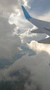 Airplane wing view out of the window on the cloudy sky background. Holiday vacation background. Wing of airplane flying above the Royalty Free Stock Photo