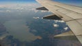 Airplane wing view out of the window on the cloudy sky The Earth Royalty Free Stock Photo