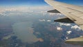 Airplane wing view out of the window on the cloudy sky The Earth background. Holiday vacation background. Wing of airplane flying Royalty Free Stock Photo