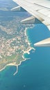 Airplane wing view out of the window on the cloudy sky The Earth and the blue sea. background. Holiday vacation background. Wing Royalty Free Stock Photo