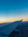 An airplane wing viewed from a passenger window Royalty Free Stock Photo