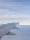 An airplane wing viewed from a passenger window Royalty Free Stock Photo