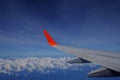 Airplane wings flying over the clouds And beautiful blue sky Looking from the plane window using a commercial plane, traveling Royalty Free Stock Photo