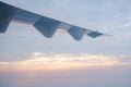 airplane wings when flying in sky at sunrise time,transportation and travel concept. Royalty Free Stock Photo