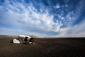 Airplane wreckage on black sand beach Royalty Free Stock Photo