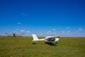 Airplanes on the airfield against the sky with clouds. Small aircraft. Background