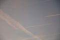 Airplanes and contrails of another airplanes in the sky.