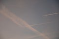 Airplanes and contrails of another airplanes in the sky.