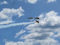 Airplanes in flight during a high-flying air show.