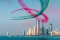 Airplanes flying above Abu Dhabi skyline for the UAE national day celebration airshow Royalty Free Stock Photo