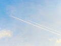 Airplanes flying with trail in the blue sky.