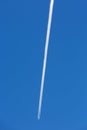 Airplanes leaving diagonal trace on a clear blue sky.