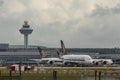 Airplanes Of Singapore Airlines At Changi International Airport With Air Traffic Control Tower, Singapore. Royalty Free Stock Photo