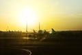 Airplanes at sunset along runway at international airport. arrival departure of the aircraft from the airfield, boarding the Royalty Free Stock Photo