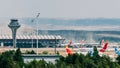 Airplanes on tarmac and iconic roof of Bajaras Airport in Madrid, Spain - dust storm