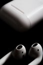 Airpods with charging case on a black background Royalty Free Stock Photo