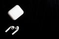Airpods with charging case on a black background Royalty Free Stock Photo