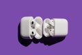 Barcelona, Spain - January 2022. Airpods pro compared with apple air pods 2 in wireless charging case on violet Royalty Free Stock Photo