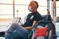 Airport attractive old man tourist boarding plane taking a flight wearing face mask. Coronavirus flu virus travel