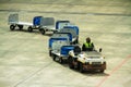 Airport baggage carrier train on tarmac