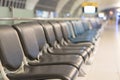 Airport blur background for air transportation travel concept with blurry bench seats for traveller or tourist on corridor Royalty Free Stock Photo