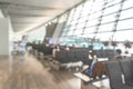 Airport blur background for air transportation travel concept with blurry bench seats for traveller or tourist on corridor Royalty Free Stock Photo