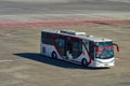 an airport bus belonging to the airline air asia prepares to pick up passengers who get off the plane at the apron