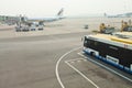 Airport bus next to gangway and airplane Royalty Free Stock Photo
