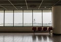 Airport chair beside the window.