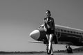 Airport and charming stewardess on blue airplane background. Portrait of charming stewardess wearing in blue uniform Royalty Free Stock Photo