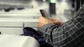 Airport Check-In: man taking out passport from his backpack and gives it for check-in. Royalty Free Stock Photo