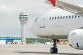 Airport control tower and terminal modern buildings with departing to taking off airplane. Royalty Free Stock Photo