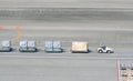 Airport crew Carrying Cargo to Plane at Narita International Airport in Tokyo, Japan