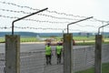 Airport employees are on the runway. The territory of the private airfield is fenced with barbed wire and a fence. The traffic