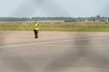 Airport employees are on the runway. The territory of the private airfield is fenced with barbed wire and a fence. The traffic