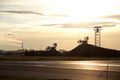 Airport equipment on flying field - high board and radiolocators against dawning sun. Horizontal image Royalty Free Stock Photo